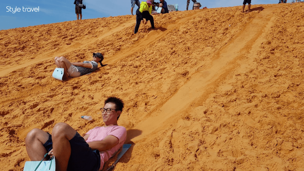 Go Sandboarding on the Red Sand Dunes